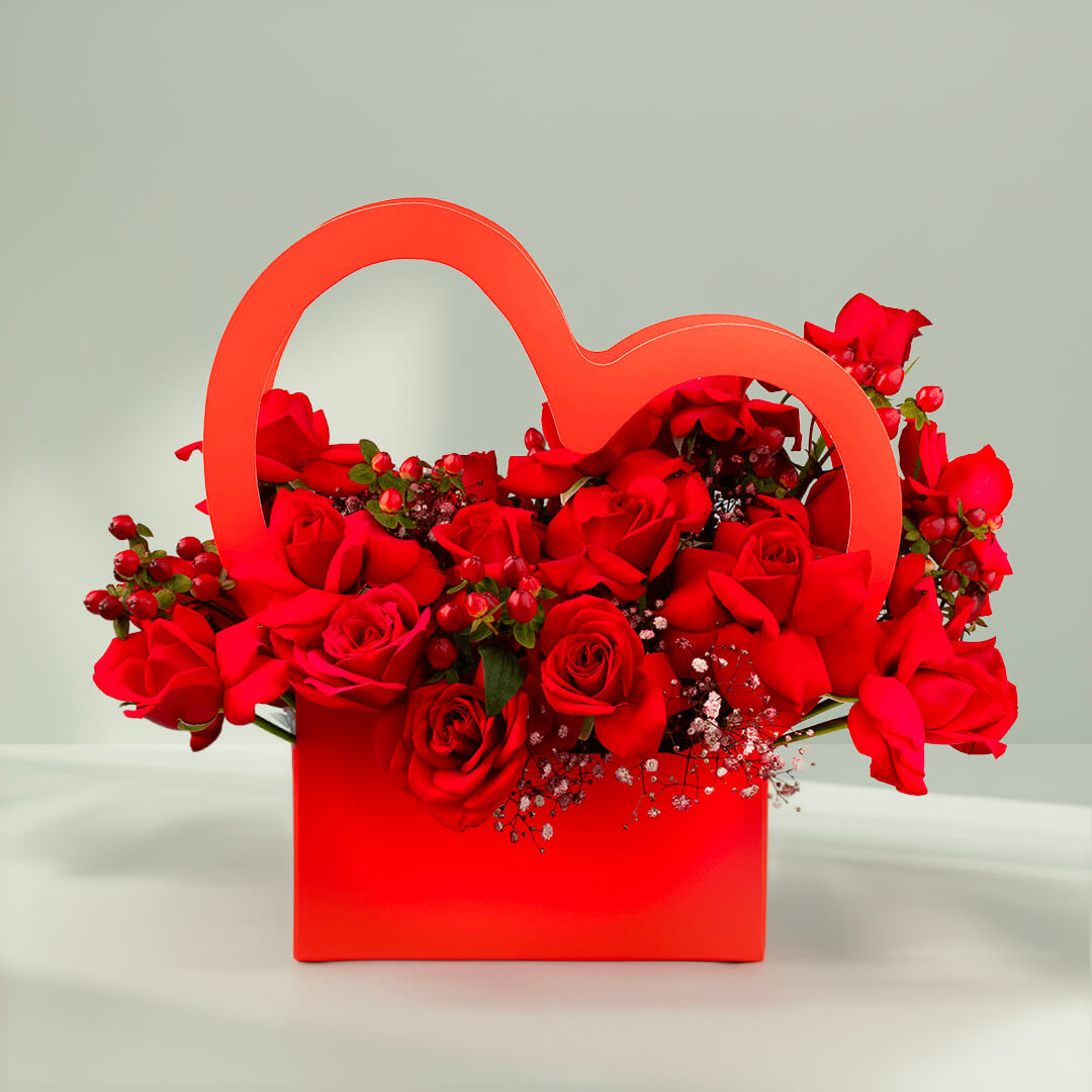 Red roses arranged in a heart-shaped flower box