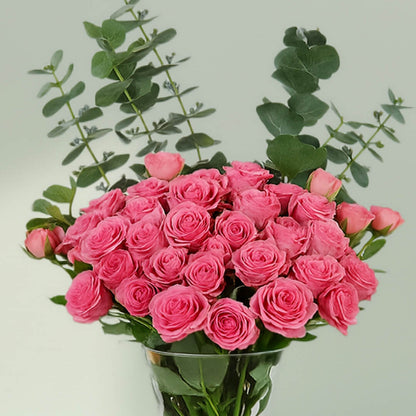 Blush Roses in Glass Vase arranged with 20 blush roses and eucalyptus greens