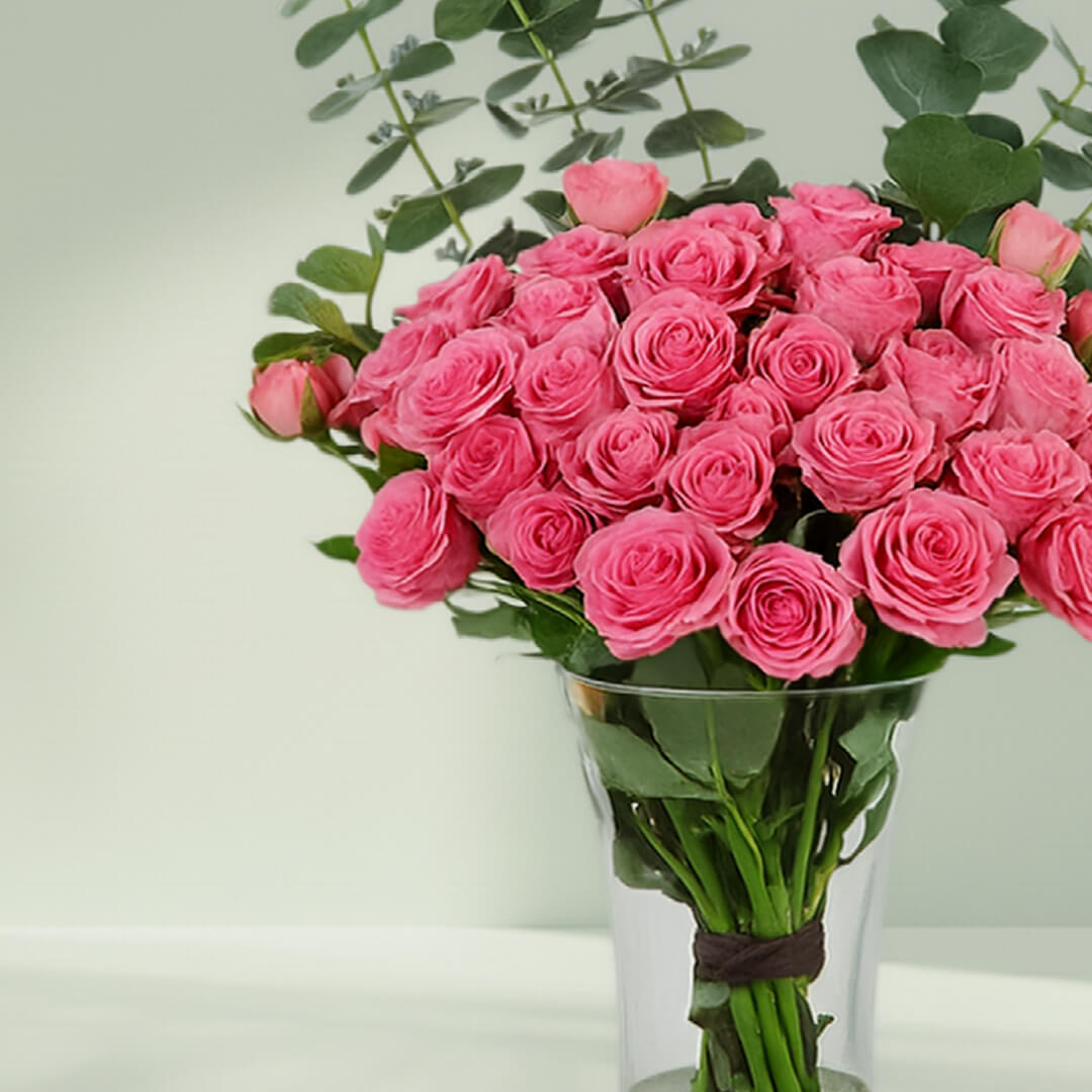 Blush Roses in Glass Vase arranged with 20 blush roses and eucalyptus greens