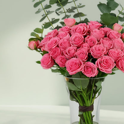 Blush Roses in Glass Vase arranged with 20 blush roses and eucalyptus greens
