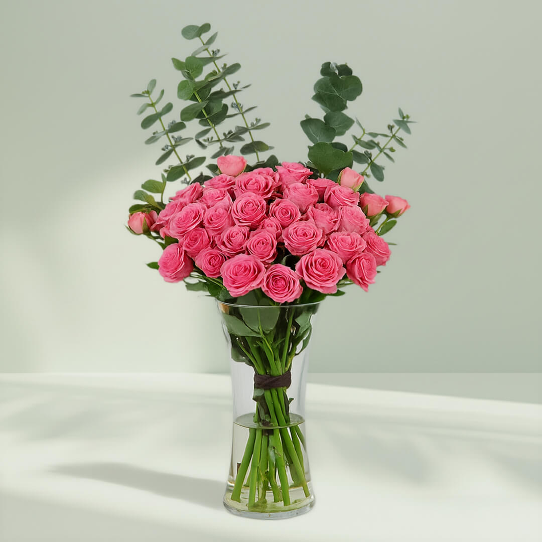 Blush Roses in Glass Vase arranged with 20 blush roses and eucalyptus greens