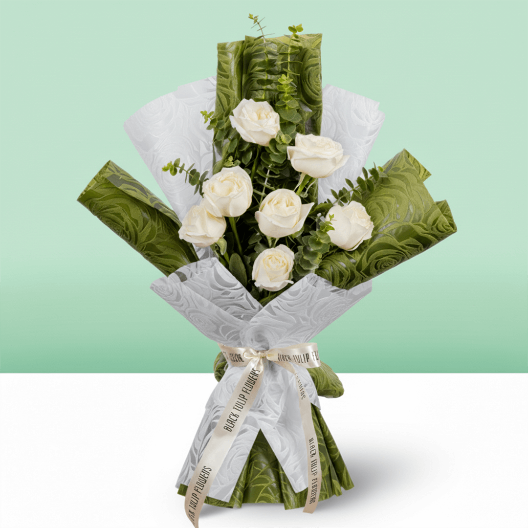 7 white roses bouquet with eucalyptus in green and white wrapping
