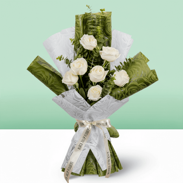7 white roses bouquet with eucalyptus in green and white wrapping