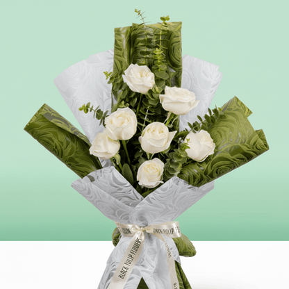 7 white roses bouquet with eucalyptus in green and white wrapping