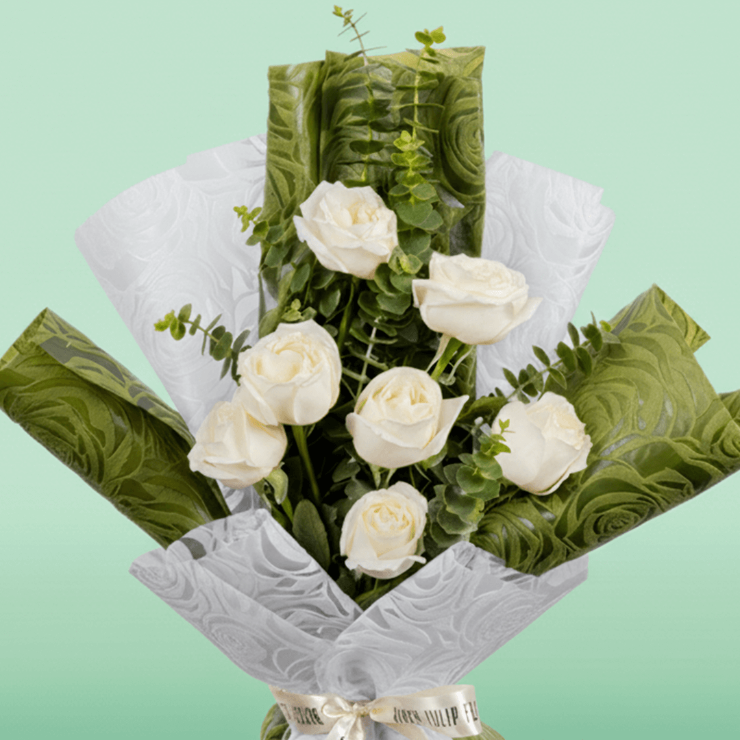 7 white roses bouquet with eucalyptus in green and white wrapping