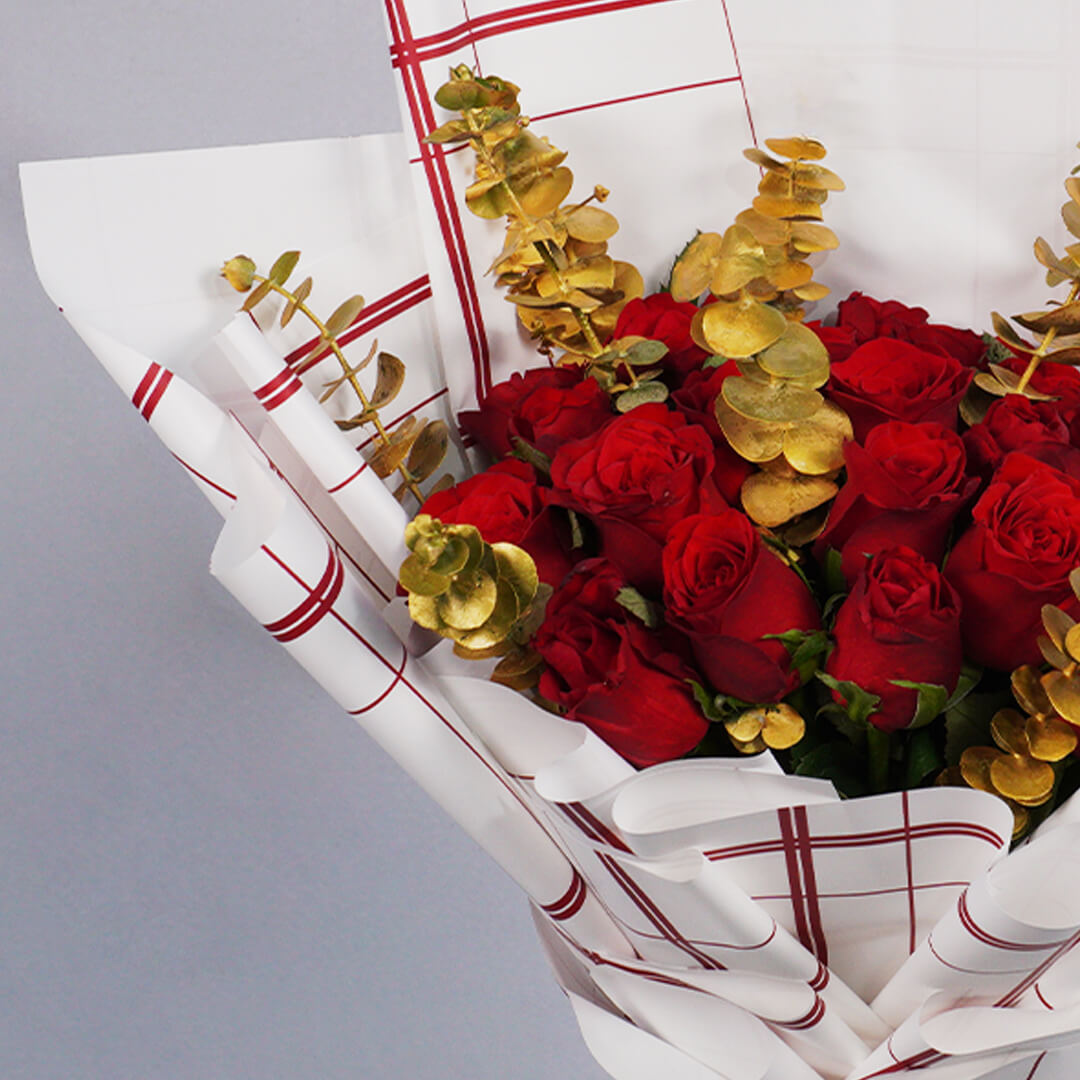 Bouquet of 26 red Roses with Eucalyptus in red and gold Korean-style wrapping.