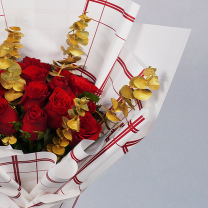Bouquet of 26 red Roses with Eucalyptus in red and gold Korean-style wrapping.