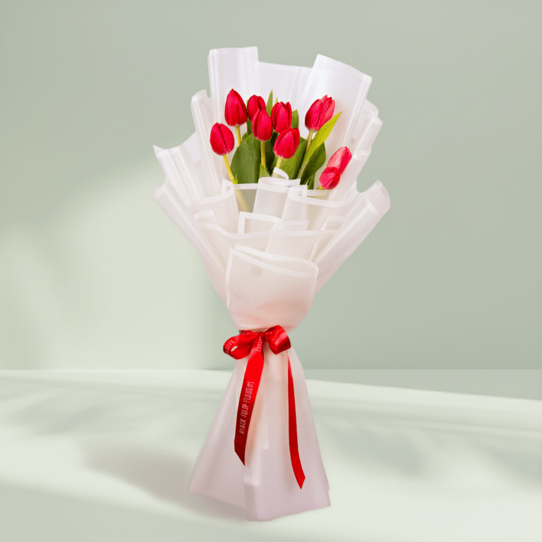 10 Stem Red Tulips Bouquet arranged with 10 red tulips in soft pink wrapping