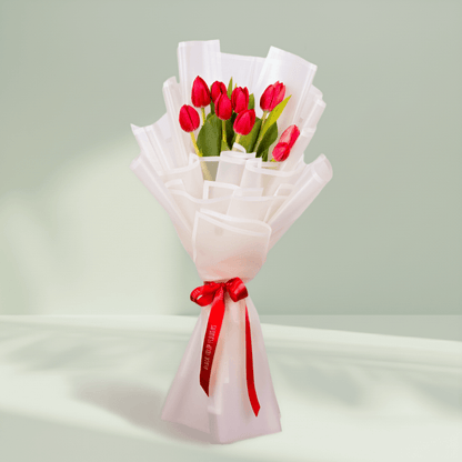 10 Stem Red Tulips Bouquet arranged with 10 red tulips in soft pink wrapping