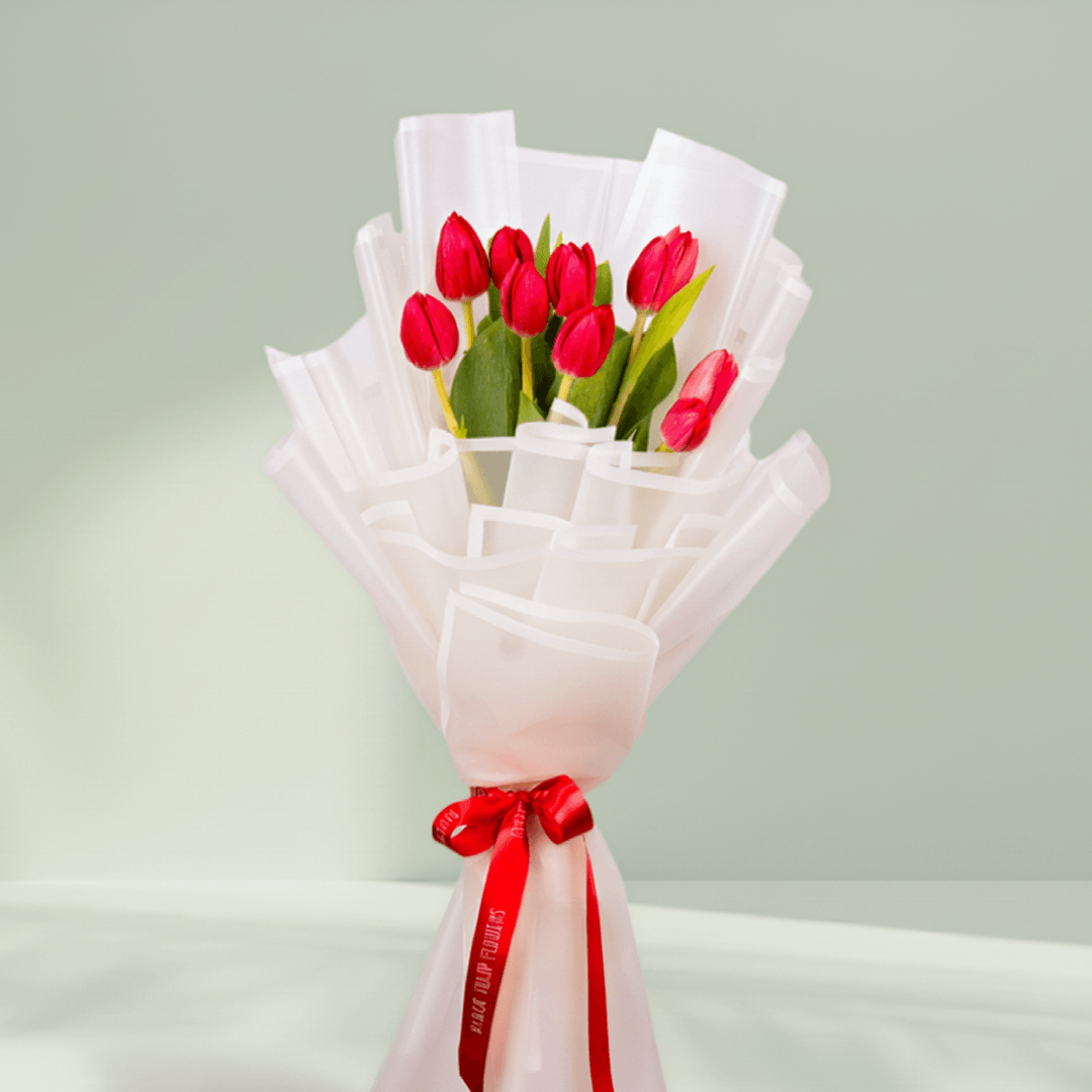 10 Stem Red Tulips Bouquet arranged with 10 red tulips in soft pink wrapping