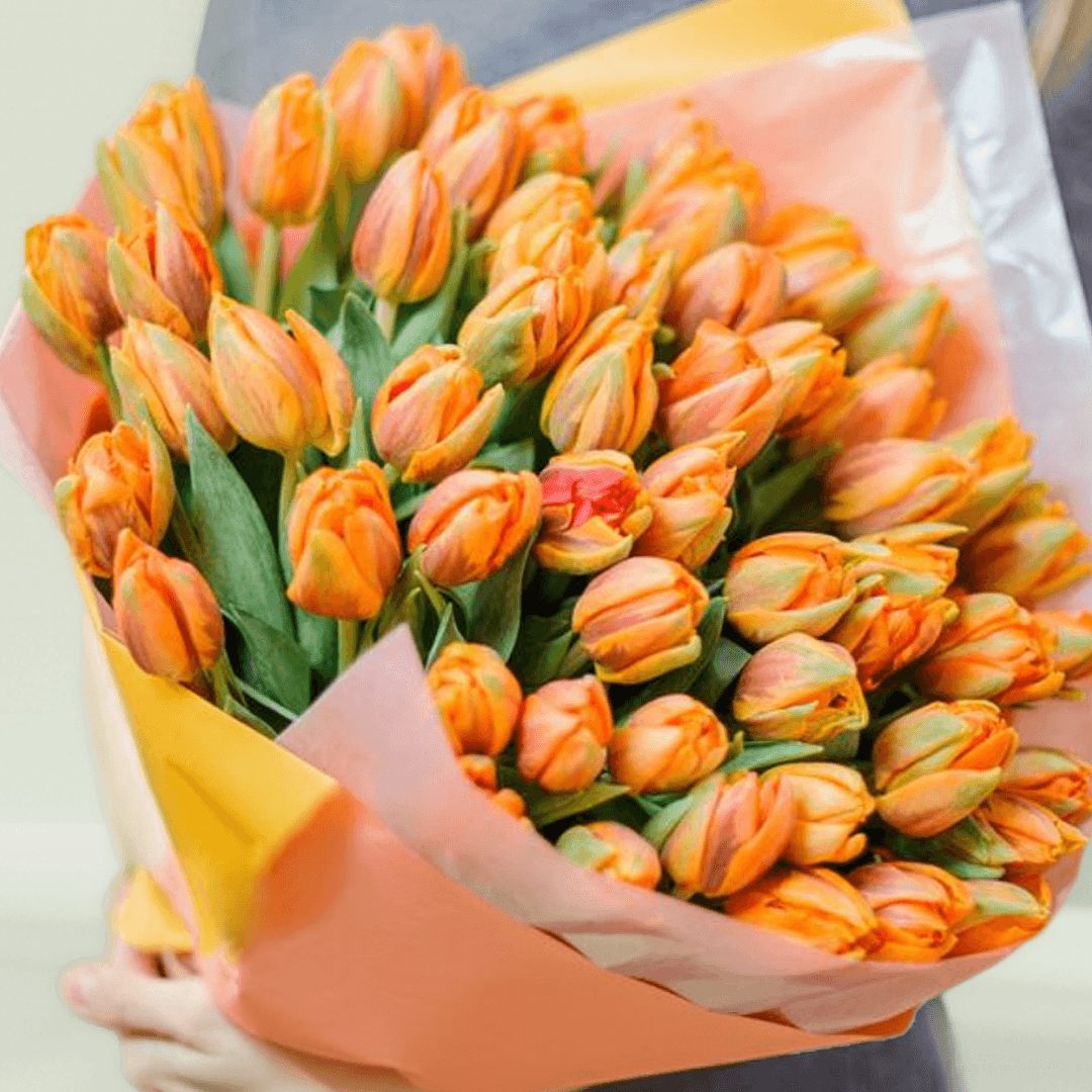A bouquet featuring 30 orange tulips in peach, orange and grey non-woven wrapping.