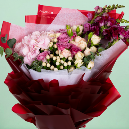 Mixed Hydrangea, Rose, Eustoma and Snapdragon bouquet in red Korean-style wrapping.
