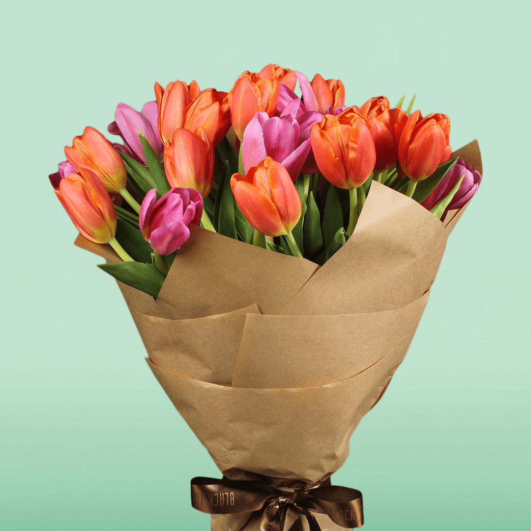 Bouquet of 30 assorted pink and orange tulips wrapped in brown non-woven paper