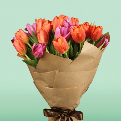 Bouquet of 30 assorted pink and orange tulips wrapped in brown non-woven paper
