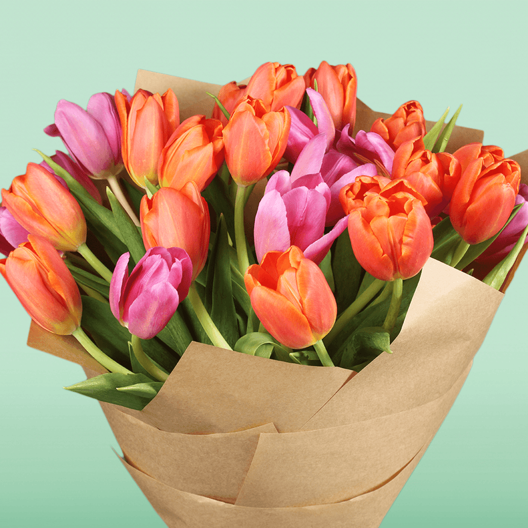 Bouquet of 30 assorted pink and orange tulips wrapped in brown non-woven paper