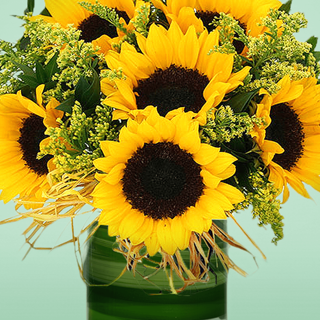 10 sunflowers and delicate fillers in a transparent glass cylinder vase.
