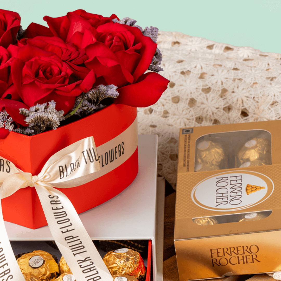 Heart-shaped red rose arrangement with Ferrero Rocher chocolates in a gift box