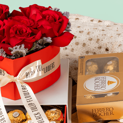 Heart-shaped red rose arrangement with Ferrero Rocher chocolates in a gift box