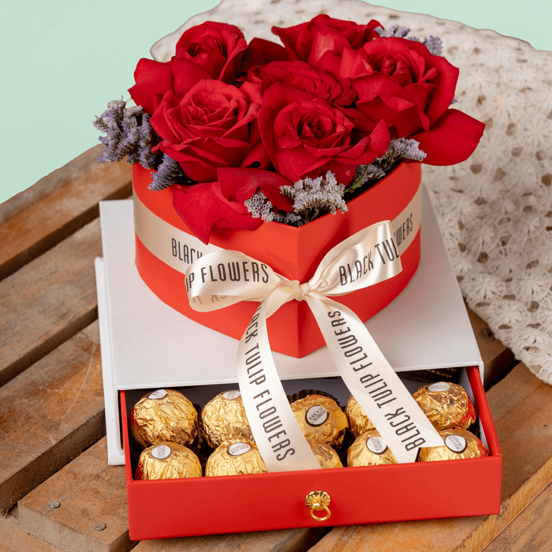 Heart-shaped red rose arrangement with Ferrero Rocher chocolates in a gift box