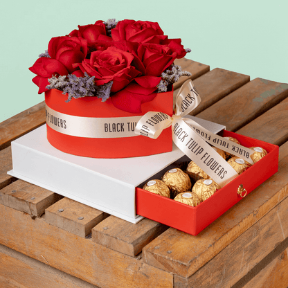 Heart-shaped red rose arrangement with Ferrero Rocher chocolates in a gift box