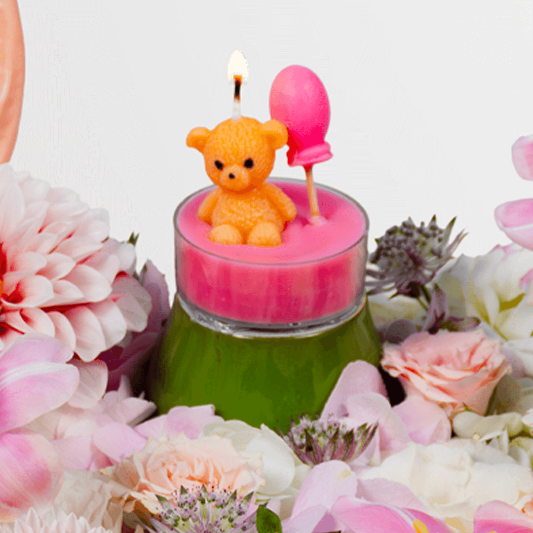 Pink lily, hydrangea and dahlia flower arrangement with anthurium, teddy bear candle and balloon in a wooden crate