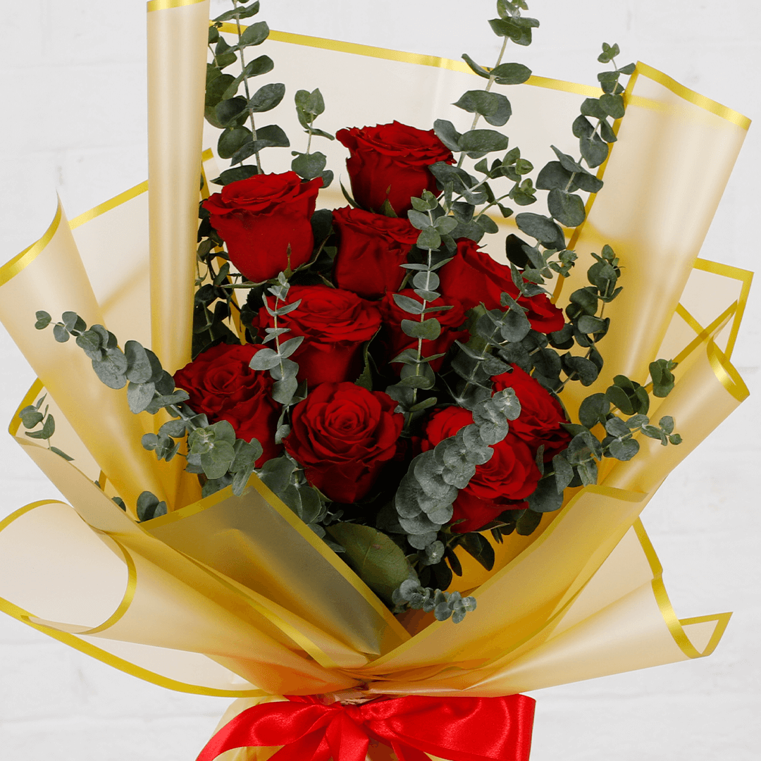 Bouquet of 10 fresh red roses with eucalyptus in a golden wrap.