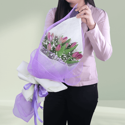 Bouquet of 10 fresh purple tulips beautifully arranged with delicate fillers