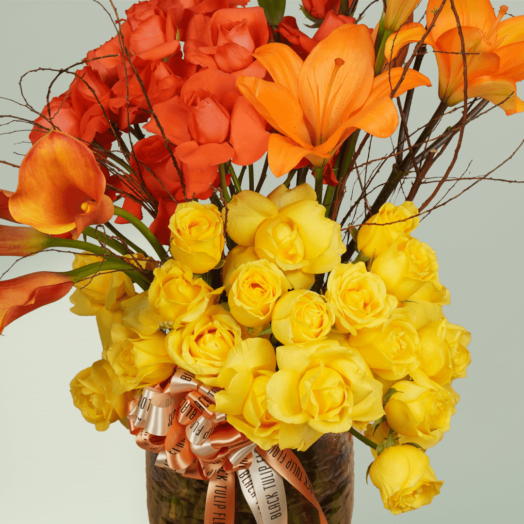Saffron Surge calla lily rose vase with lilies and fillers in premium glass vase
