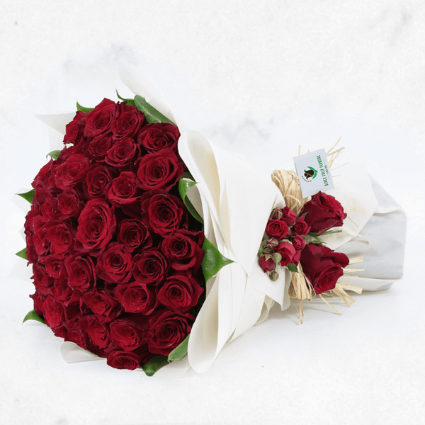 A luxury bouquet of 50 red roses in white wrap.