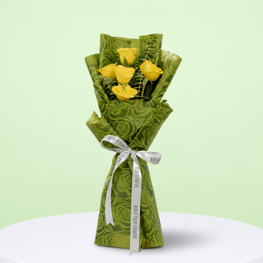 5 yellow roses bouquet with eucalyptus in green wrapping