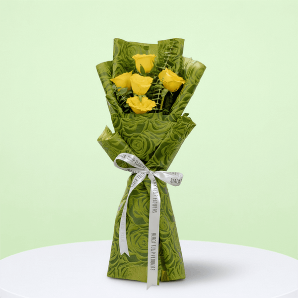5 yellow roses bouquet with eucalyptus in green wrapping