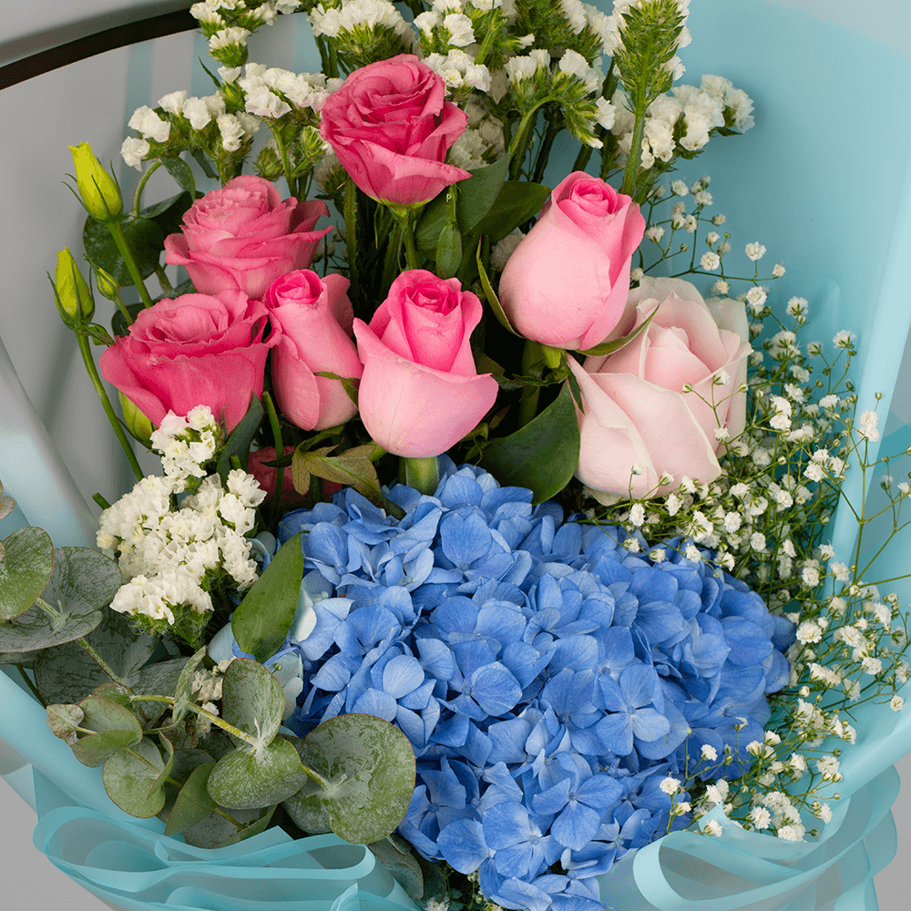 Pastel blue Hydrangea bouquet with pink Roses, Eustoma, Statice and white Gypsophila in Korean-style blue wrapping.