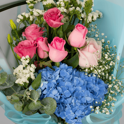 Pastel blue Hydrangea bouquet with pink Roses, Eustoma, Statice and white Gypsophila in Korean-style blue wrapping.