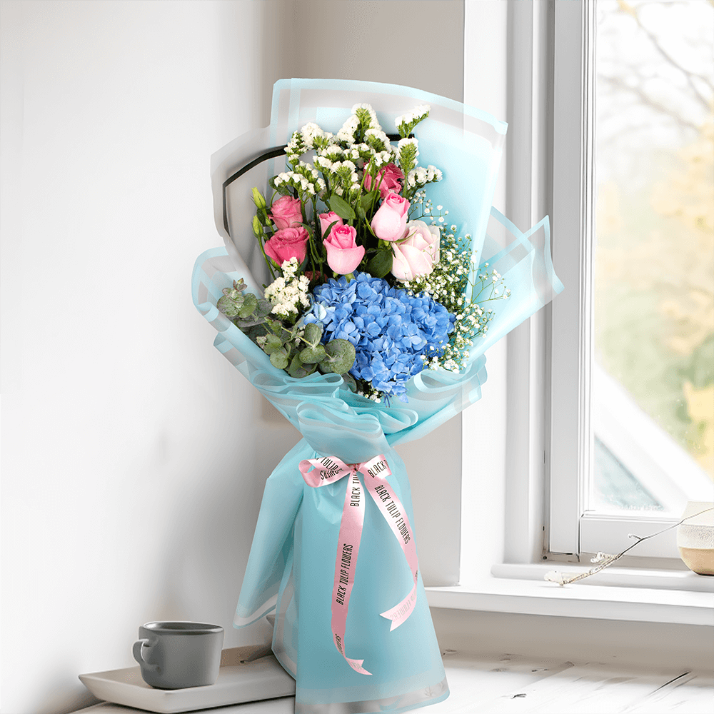 Pastel blue Hydrangea bouquet with pink Roses, Eustoma, Statice and white Gypsophila in Korean-style blue wrapping.