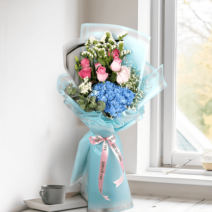 Pastel blue Hydrangea bouquet with pink Roses, Eustoma, Statice and white Gypsophila in Korean-style blue wrapping.