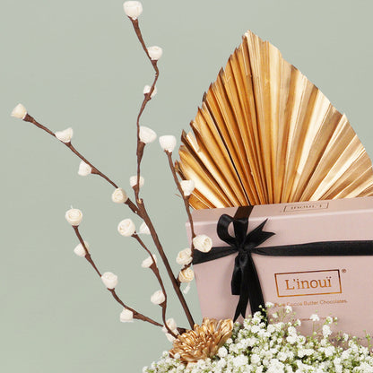 A festive Diwali flower box featuring white chrysanthemums, dry flowers and chocolates