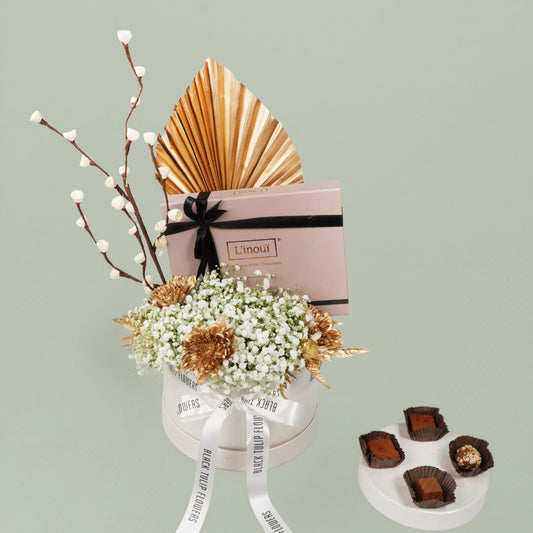 A festive Diwali flower box featuring white chrysanthemums, dry flowers and chocolates