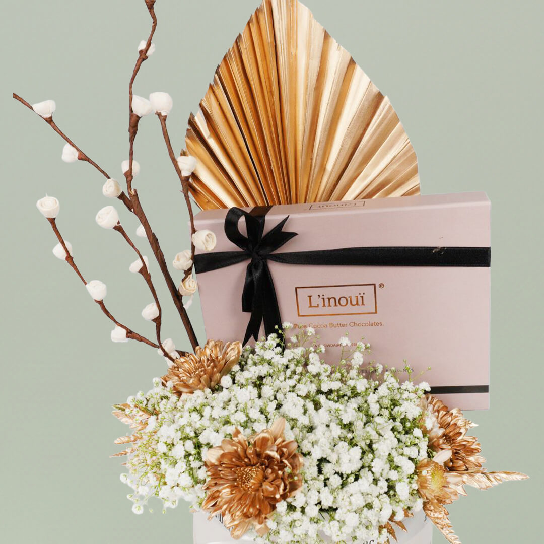 A festive Diwali flower box featuring white chrysanthemums, dry flowers and chocolates