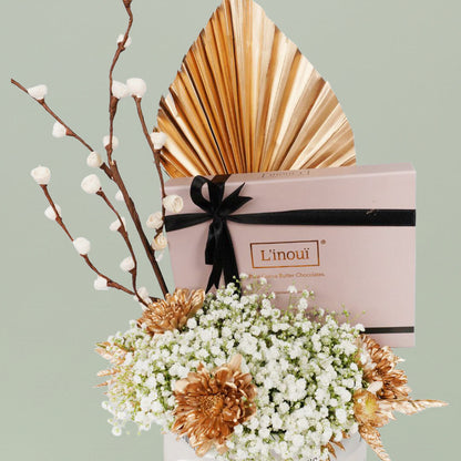 A festive Diwali flower box featuring white chrysanthemums, dry flowers and chocolates