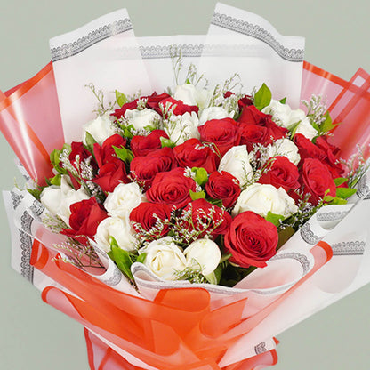 Two colored roses bouquet beautifully arranged with fresh flowers, perfect for romantic celebrations and gifting.