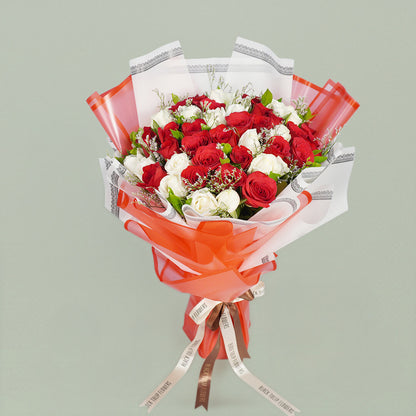 Two colored roses bouquet beautifully arranged with fresh flowers, perfect for romantic celebrations and gifting.