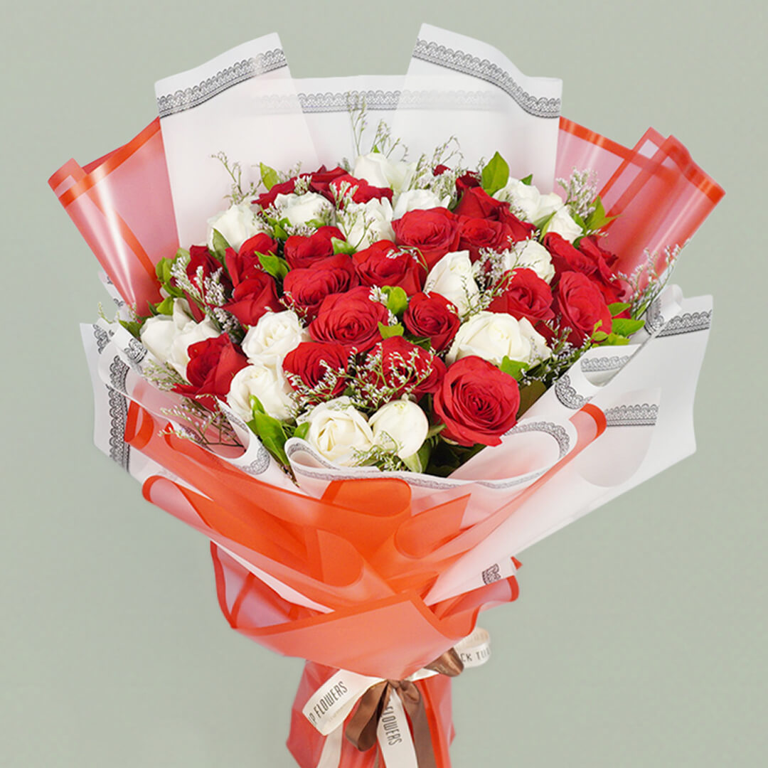 Two colored roses bouquet beautifully arranged with fresh flowers, perfect for romantic celebrations and gifting.