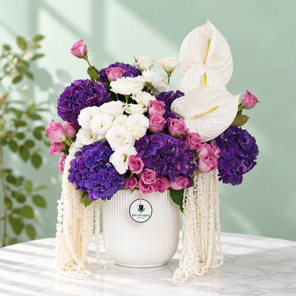 Mixed flowers featuring hydrangea, eustoma, roses and dried amaranthus in a vase