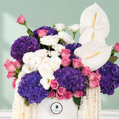 Mixed flowers featuring hydrangea, eustoma, roses and dried amaranthus in a vase