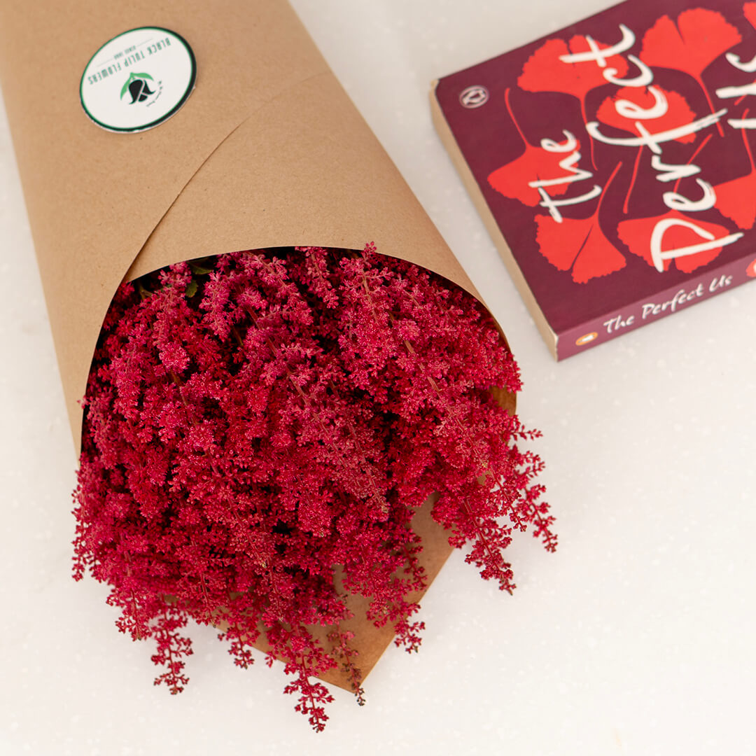 Fresh Astilbe cut flowers neatly arranged in brown paper wrapping