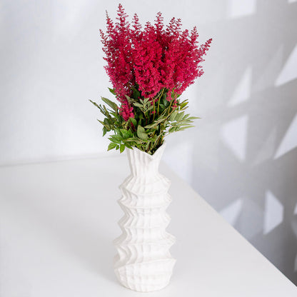 Fresh Astilbe cut flowers neatly arranged in brown paper wrapping