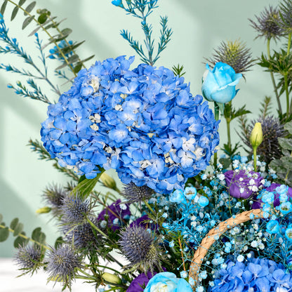 Rectangle basket filled with blue hydrangea, roses, orchid, veronica, and eustoma.