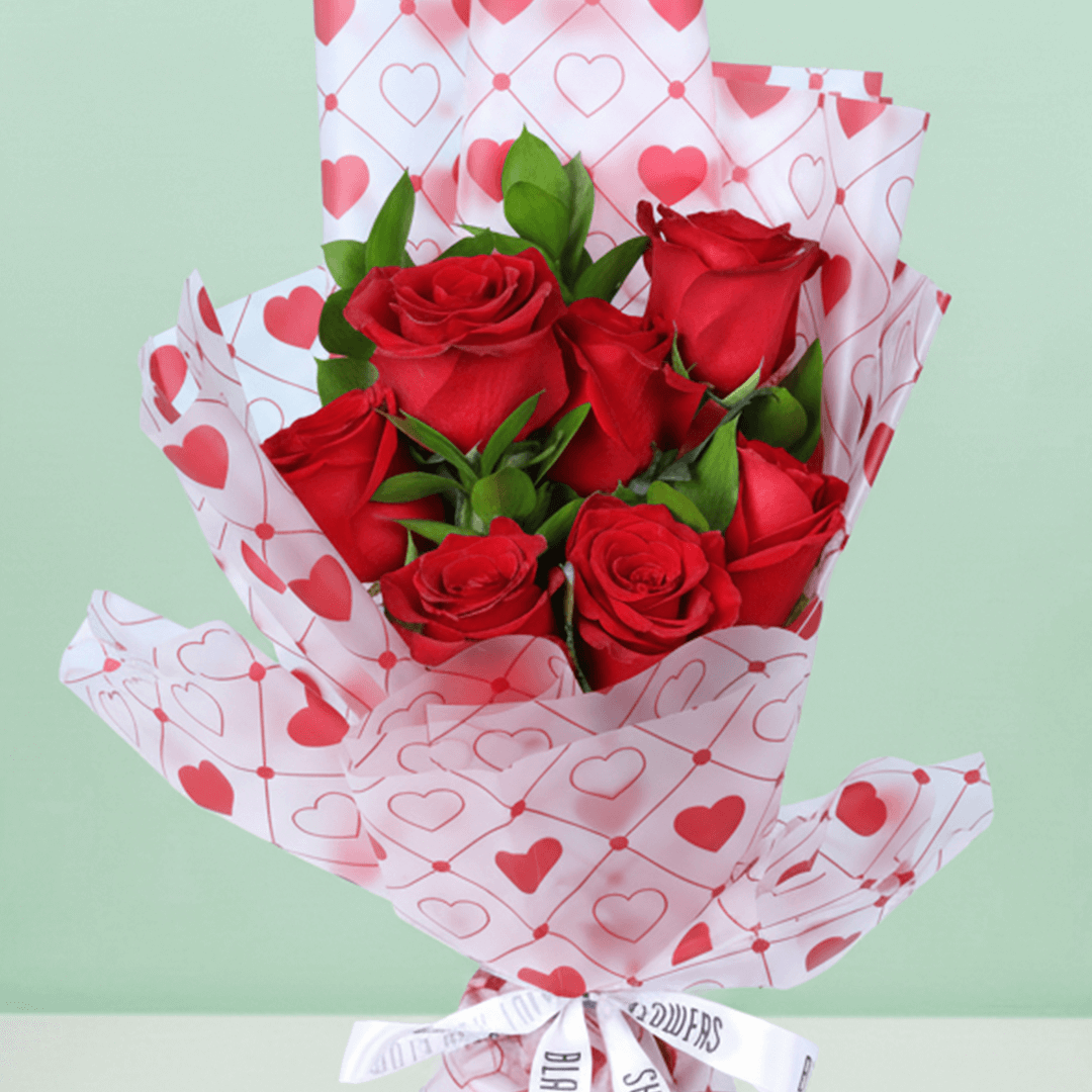 Blush Love 7 Red Rose Bouquet arranged with 7 red roses with fresh greenery