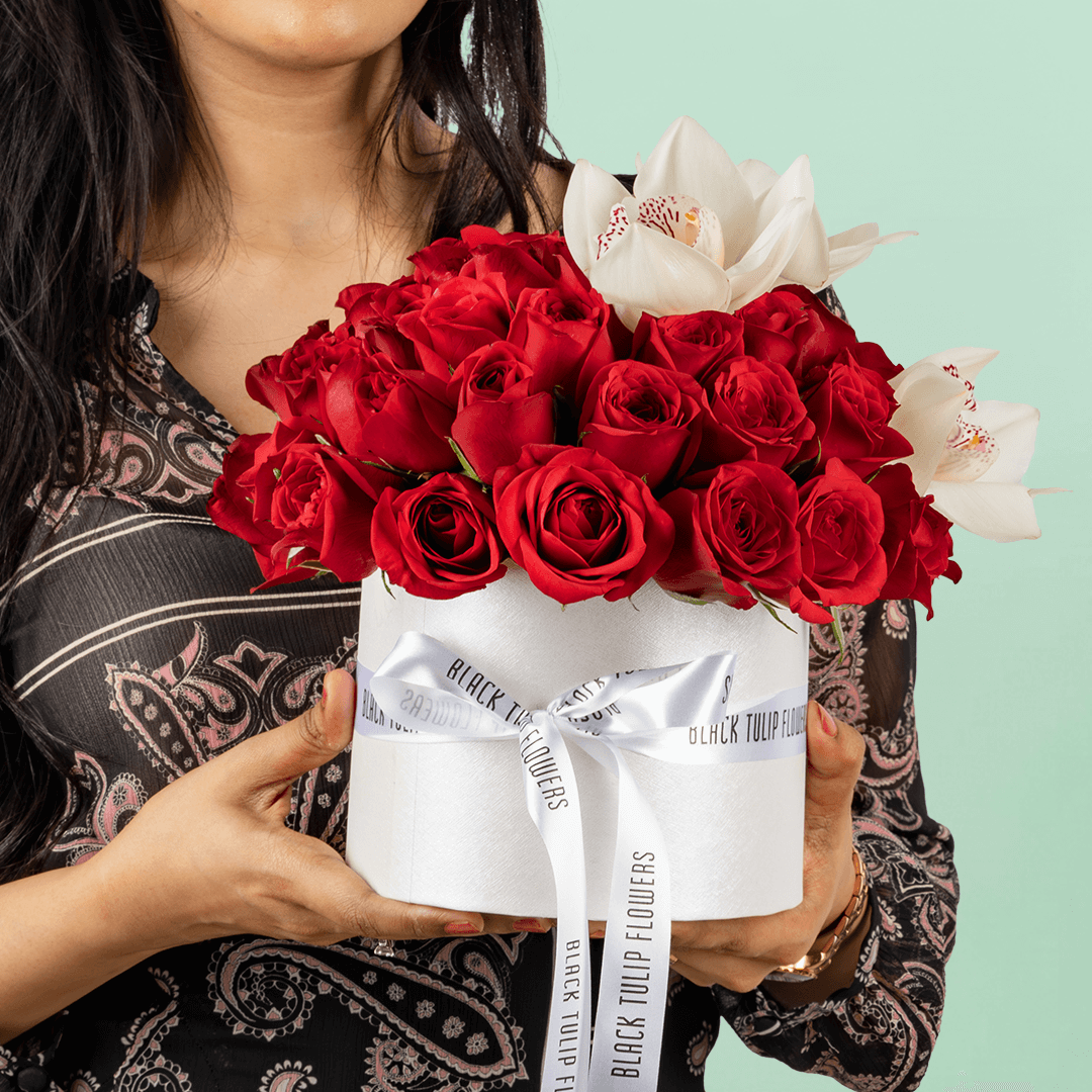 50 Red Roses & White Orchid Box arranged with 50 red roses, white cymbidium orchids and fresh foliage