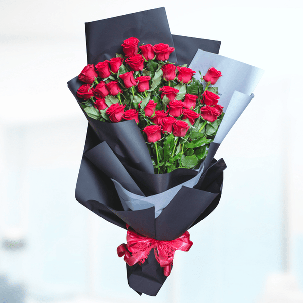 A bouquet of 30 red roses wrapped in layered black and grey non-woven paper